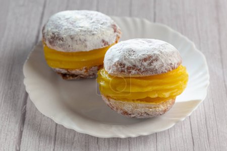 Photo for Berlin balls. Bread filled with pastry cream and topped with sprinkled sugar. - Royalty Free Image