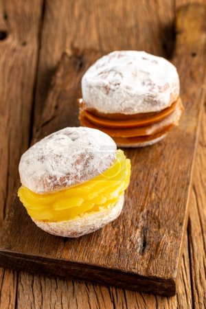 Photo for Berlin balls. Bread filled with pastry cream and topped with sprinkled sugar. - Royalty Free Image