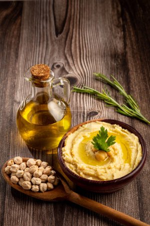 Photo for Chickpeas hummus with olive oil in the bowl. - Royalty Free Image
