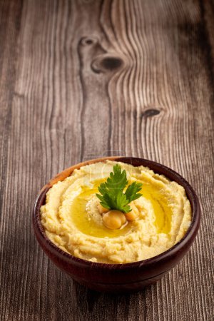 Chickpeas hummus with olive oil in the bowl.