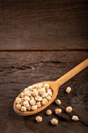 Photo for Raw chickpeas in wooden spoon. - Royalty Free Image