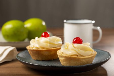 Photo for Lemon tartlets decorated with cherry. - Royalty Free Image