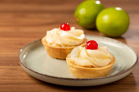 Photo for Lemon tartlets decorated with cherry. - Royalty Free Image
