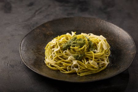 Photo for Pasta spaghetti with pesto sauce and basil leaf. - Royalty Free Image