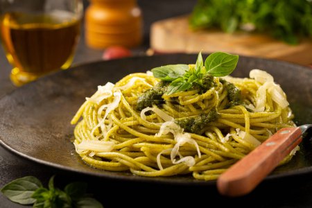 Photo for Pasta spaghetti with pesto sauce and basil leaf. - Royalty Free Image
