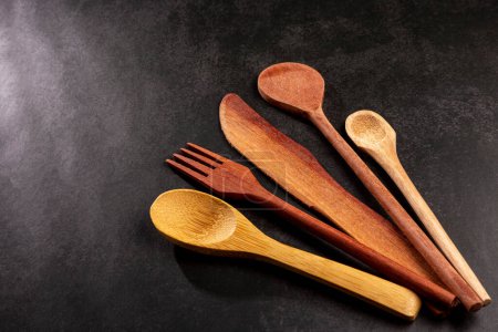 Photo for Wooden cutlery on dark background. - Royalty Free Image