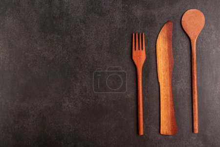 Photo for Wooden cutlery on dark background. - Royalty Free Image
