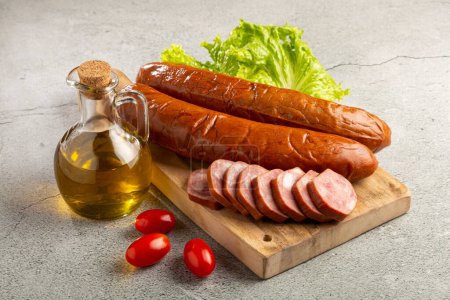 Photo for Raw smoked sausage on the table. Calabrese sausage. - Royalty Free Image