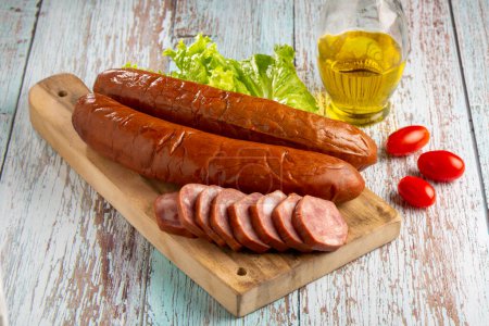 Photo for Raw smoked sausage on the table. Calabrese sausage. - Royalty Free Image