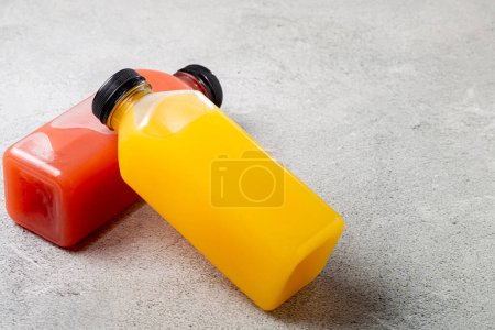 Healthy fruit smoothies in plastic bottles.