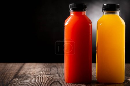 Photo for Healthy fruit smoothies in plastic bottles. - Royalty Free Image