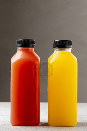 Photo for Healthy fruit smoothies in plastic bottles. - Royalty Free Image