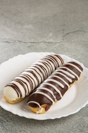 Photo for Eclair. Tasty chocolate eclair on the table. - Royalty Free Image