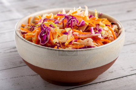 Photo for Coleslaw salad with white cabbage, red cabbage and sliced carrots - Royalty Free Image