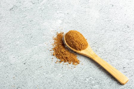 Photo for Brown sugar in wooden spoon on the table. - Royalty Free Image