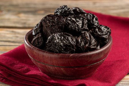 Photo for Bowl with prunes on the table. - Royalty Free Image