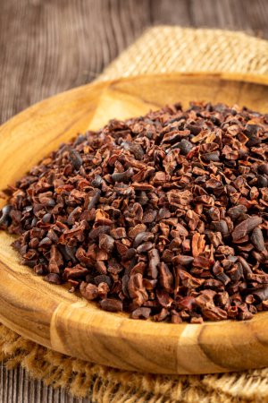 Photo for Cocoa nibs on wooden plate. - Royalty Free Image