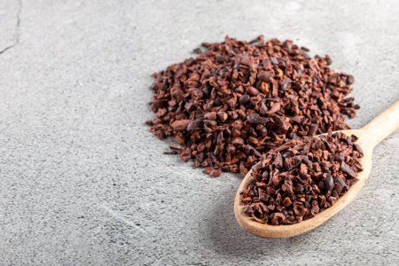 Photo for Bowl with cocoa nibs on the table. - Royalty Free Image