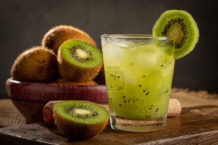 Brazilian Kiwi Caipirinha. Cachaa drink with kiwi, on wooden background