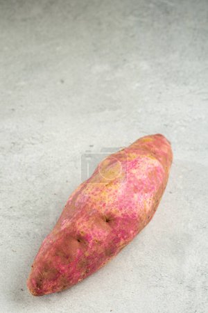 Photo for Raw sweet potato on the table. - Royalty Free Image