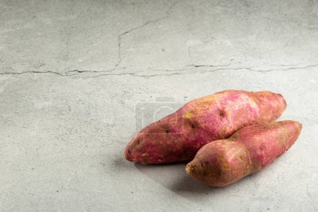 Photo for Raw sweet potato on the table. - Royalty Free Image