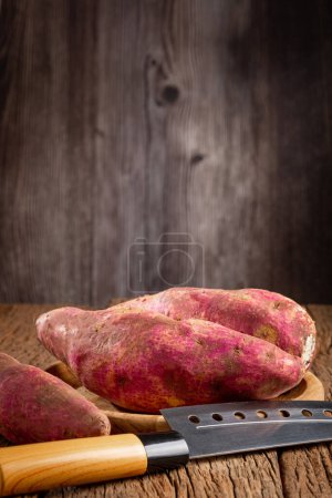 Raw sweet potato on the table.
