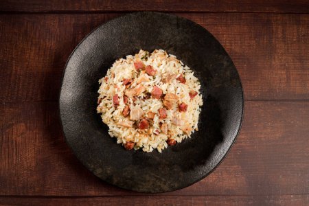 Photo for Rice dish with pieces of shank and bacon. - Royalty Free Image