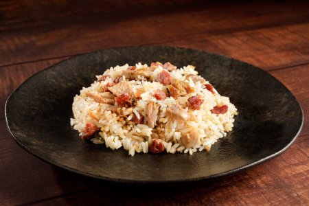 Photo for Rice dish with pieces of shank and bacon. - Royalty Free Image