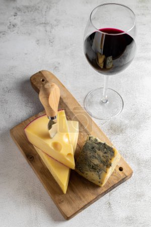 Cheese board with a glass of red wine.