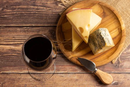 Photo for Cheese board with a glass of red wine. - Royalty Free Image