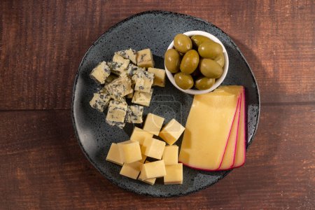 Photo for Plate of different cheeses with a glass of wine. Cheese board. - Royalty Free Image