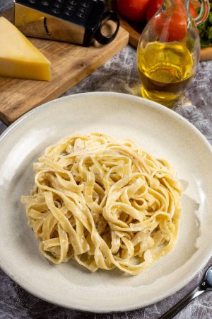 Photo for Delicious fettuccine pasta with white cheese sauce. Fettuccine pasta with Alfredo sauce. - Royalty Free Image