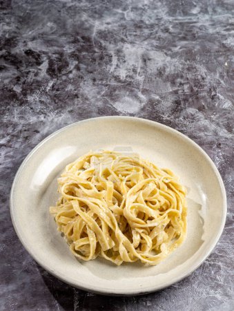 Photo for Delicious fettuccine pasta with white cheese sauce. Fettuccine pasta with Alfredo sauce. - Royalty Free Image