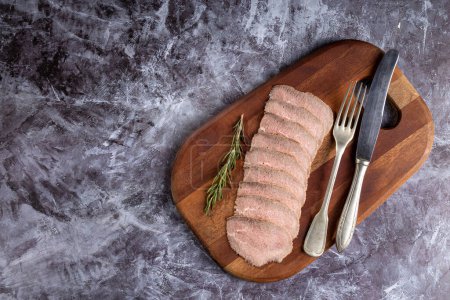 Photo for Sliced roast beef on cutting board. - Royalty Free Image