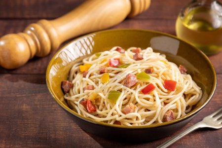 Photo for Plate with spaghetti, bacon and chopped vegetables. - Royalty Free Image