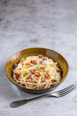 Photo for Plate with spaghetti, bacon and chopped vegetables. - Royalty Free Image