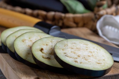 Photo for Sliced eggplant on the cutting board on the table. - Royalty Free Image