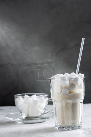 White sugar cubes in clear glass cups.