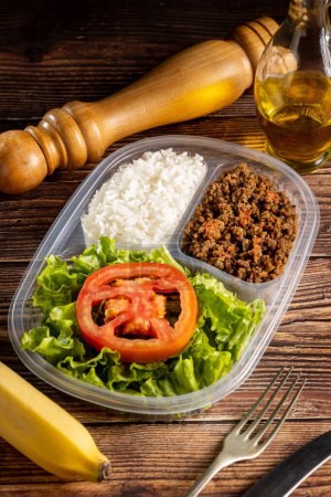Photo for Lunchbox with lettuce salad with tomato, rice and ground beef. - Royalty Free Image