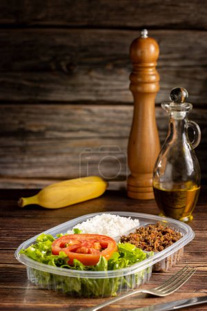 Photo for Lunchbox with lettuce salad with tomato, rice and ground beef. - Royalty Free Image