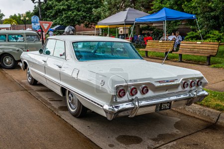 Photo for Des Moines, IA - July 01, 2022: High perspective rear corner view of a 1963 Chevrolet Impala 4 door Hardtop at a local car show. - Royalty Free Image
