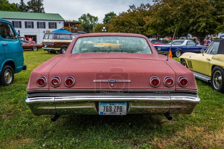 Photo for Des Moines, IA - July 01, 2022: High perspective rear view of a 1965 Chevrolet Impala Hardtop Coupe at a local car show. - Royalty Free Image