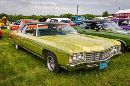 Photo for Iola, WI - July 07, 2022: High perspective front corner view of a 1971 Chevrolet Impala 2 Door Hardtop at a local car show. - Royalty Free Image