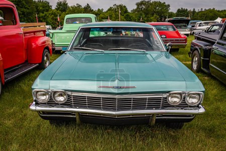 Photo for Iola, WI - July 07, 2022: High perspective front view of a 1965 Chevrolet Impala 2 Door Hardtop at a local car show. - Royalty Free Image