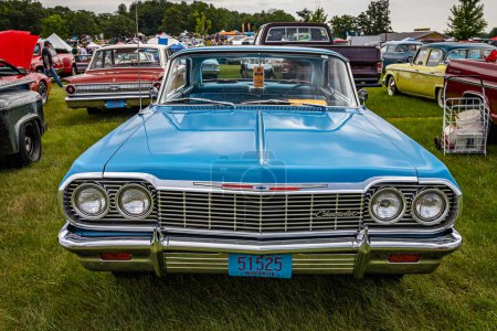 Photo for Iola, WI - July 07, 2022: High perspective front view of a 1964 Chevrolet Impala Sport Coupe at a local car show. - Royalty Free Image