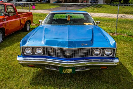 Photo for Iola, WI - July 07, 2022: High perspective front view of a 1973 Chevrolet Impala 2 Door Hardtop at a local car show. - Royalty Free Image