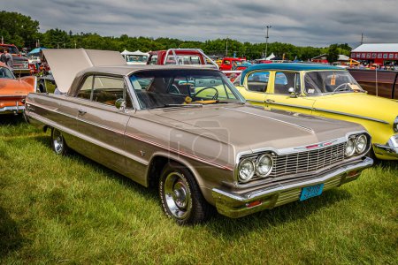 Photo for Iola, WI - July 07, 2022: High perspective front corner view of a 1964 Chevrolet Impala 2 Door Hardtop at a local car show. - Royalty Free Image