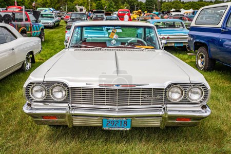 Photo for Iola, WI - July 07, 2022: High perspective front view of a 1964 Chevrolet Impala 4 Door Sedan at a local car show. - Royalty Free Image
