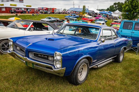Photo for Iola, WI - July 07, 2022: High perspective front corner view of a 1966 Pontiac GTO Hardtop Coupe at a local car show. - Royalty Free Image