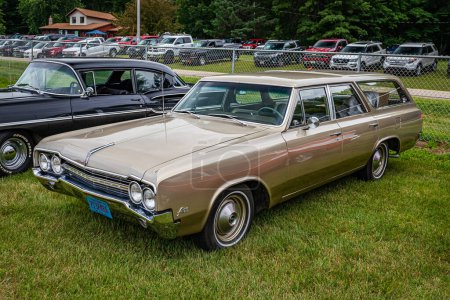 Photo for Iola, WI - July 07, 2022: High perspective front corner view of a 1965 Oldsmobile F-85 Station Wagon at a local car show. - Royalty Free Image